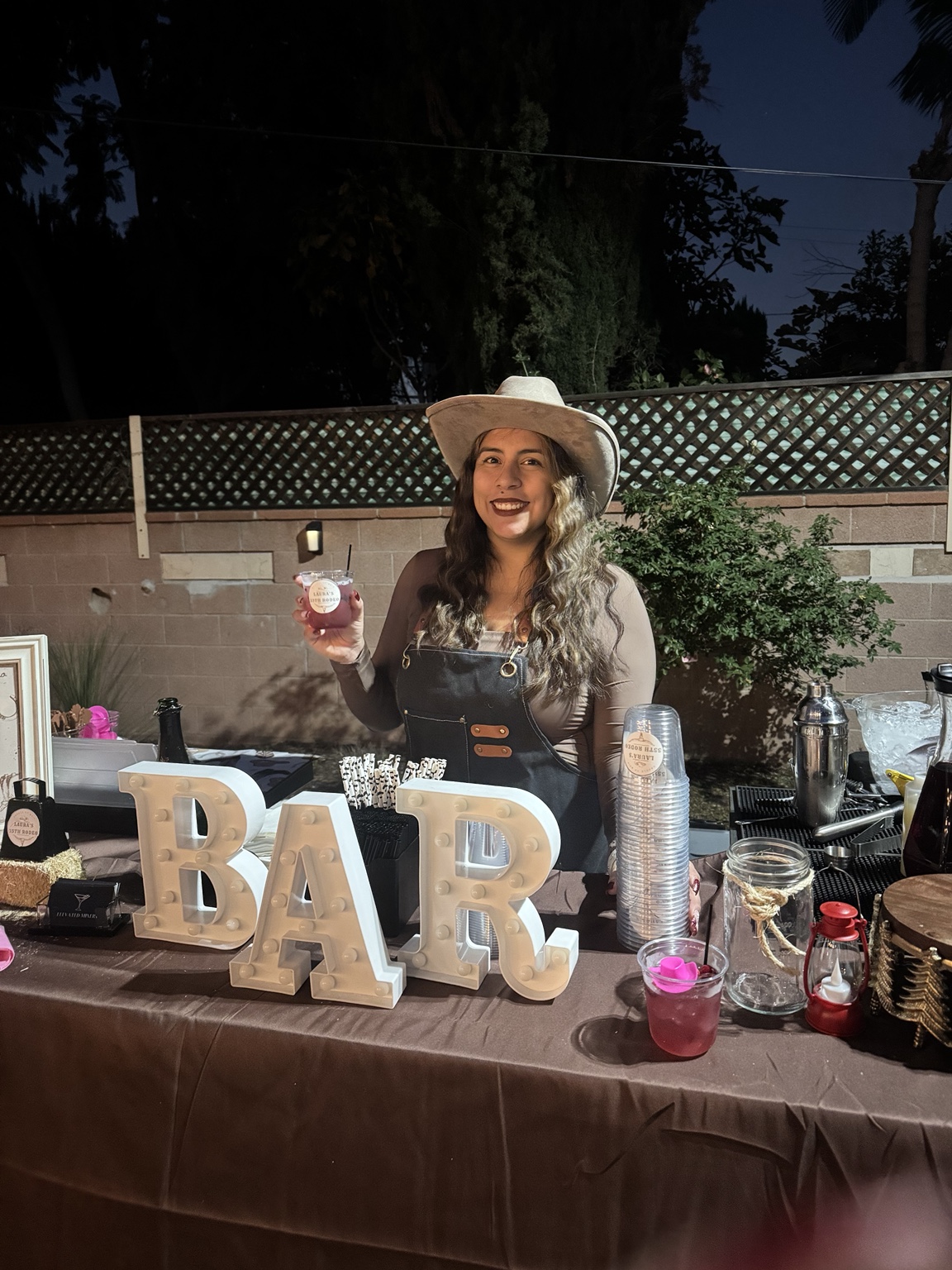 Arianne, co-owner of Elevated Mixers, serving a cocktail at an event